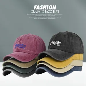 Detail view of various vintage washed cotton baseball caps with EST.1993 embroidery