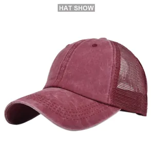 Detail of burgundy mesh trucker hat with washed cotton fabric and premium stitching