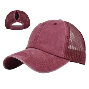 Detail of burgundy ponytail mesh cap showing washed cotton texture and breathable back