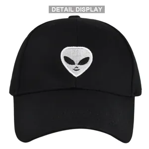 Close-up of the white alien embroidery and fine fabric texture on this black baseball cap
