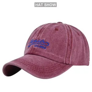 Close-up of vintage washed burgundy baseball cap showing blue EST.1993 embroidery details