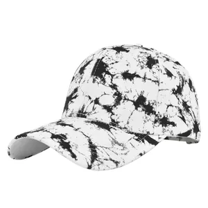 Detailed view of tie-dye canvas baseball cap featuring black and white ink texture pattern