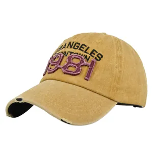 Detailed shot of yellow vintage baseball cap with 1981 embroidery and distressed brim