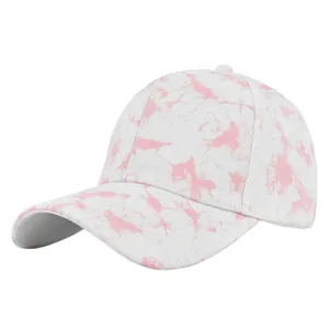 Detailed view of pink tie-dye pattern on white cotton baseball cap with twill texture