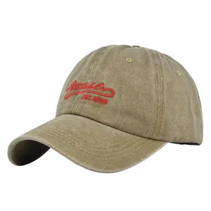Detail view of khaki washed cotton baseball cap with red Nubble EST.1993 3D embroidery