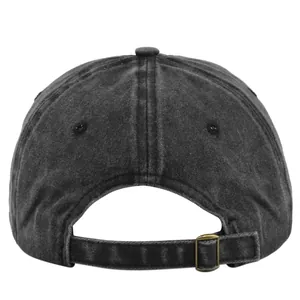 Detail view of washed black vintage baseball cap showing metal buckle strap and cotton texture