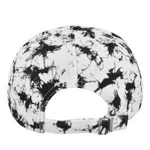 Detail view of tie-dye baseball cap featuring an adjustable metal buckle and cotton texture