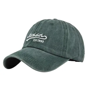 Detail of the white Stubble EST.1993 embroidery on the dark green washed cotton cap