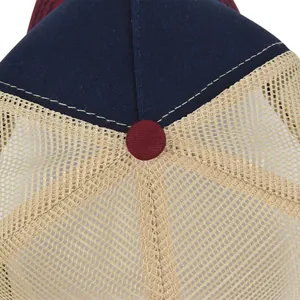 Detail of truck cap showing navy cotton fabric, khaki mesh, and white stitching lines