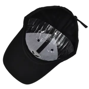 Detail of baseball cap interior showing alien head embroidery and adjustable metal buckle