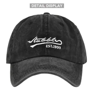 Detailed view of white Stubble embroidery on washed cotton retro black baseball cap