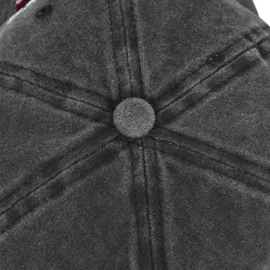 Detailed close-up of the washed cotton fabric and top button on a vintage baseball cap