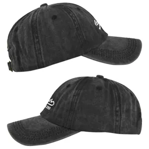 Detailed close-up of white vintage embroidery on washed charcoal canvas baseball cap
