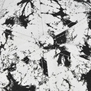 Macro shot of the black and white tie-dye cotton fabric texture on a baseball cap top