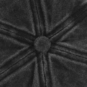Macro detail of black corduroy fabric texture and stitching on top of the baseball cap
