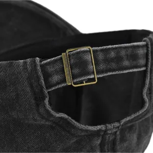 Close-up of adjustable metal buckle and vintage washed fabric texture on baseball cap