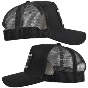 Detail of a black trucker hat featuring breathable mesh panels and a custom side patch