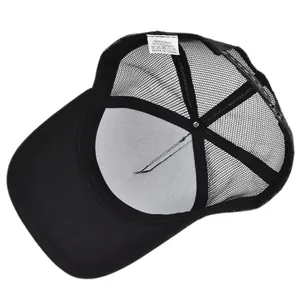 Detail of black mesh trucker hat showing inner lining and white composition label