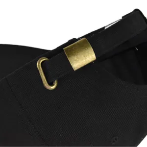 Close-up of black baseball cap with adjustable vintage brass metal buckle and strap
