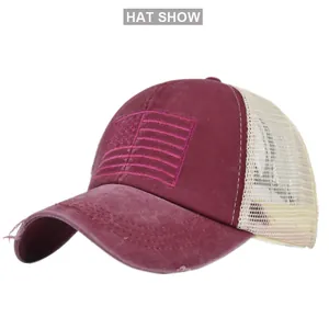 Close-up of distressed brim and American flag embroidery on mesh ponytail baseball cap