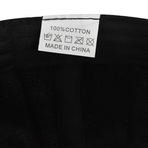Detail shot of the 100% cotton fabric and washing label on the black baseball cap
