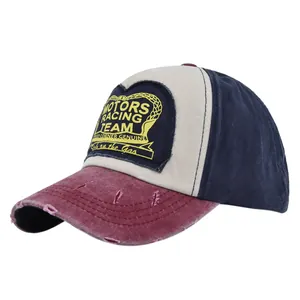 Detail of distressed brim and vintage motors racing team embroidery on baseball cap