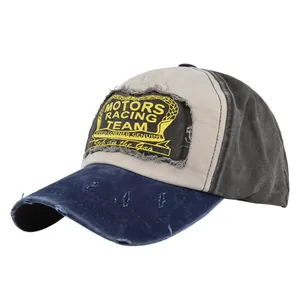 Detailed close-up of MOTORS RACING TEAM embroidery and distressed fabric on baseball cap