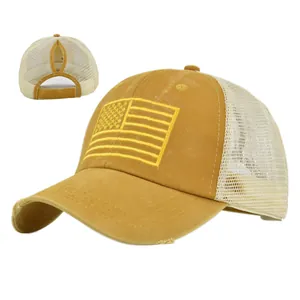 Detail of yellow mesh ponytail baseball cap with American flag embroidery and distressed brim