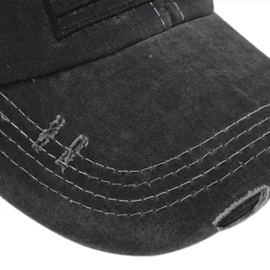 Close-up of distressed brim on washed cotton baseball cap with white contrast stitching
