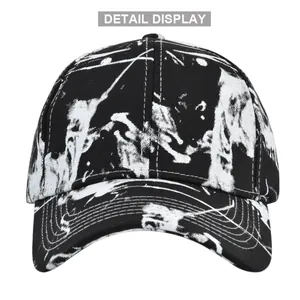 Detail view of tie-dye baseball cap with black and white graffiti pattern and stitching