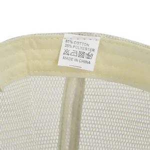 Detail of internal care label on mesh baseball cap showing 65% cotton fabric composition