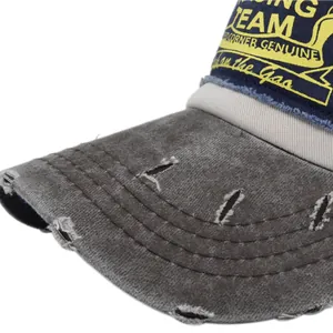 Detail of distressed brim and racing team embroidery on vintage mesh baseball cap