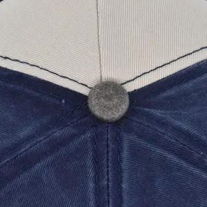 Close-up of dual-tone cotton twill baseball cap top showing detailed stitching and button