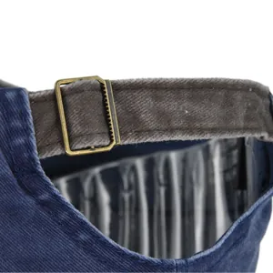 Detail of adjustable metal slider buckle and washed cotton fabric on navy baseball cap
