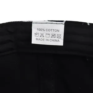 Close-up of internal wash label showing 100% cotton material on black baseball cap