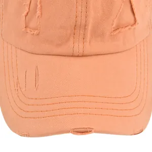 Macro view of distressed edge details and frayed holes on a vintage washed cotton baseball cap