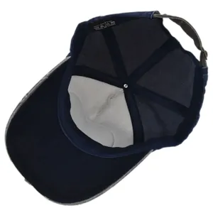 Detail of the 100% cotton inner lining and adjustable metal buckle on navy baseball cap