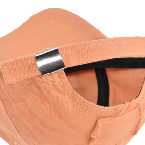 Detail of vintage washed pink baseball cap with adjustable metal buckle and frayed edge