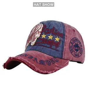 Close-up of vintage navy and burgundy baseball cap with distressed embroidery details