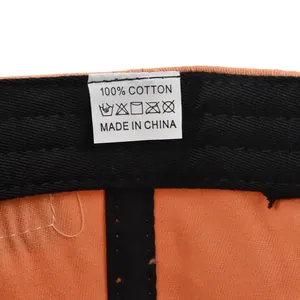 Detail view of cotton baseball cap interior showing 100% cotton label and stitching