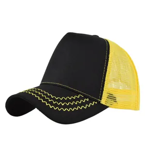 Detail view of the black and yellow trucker hat with wave stitching and breathable mesh