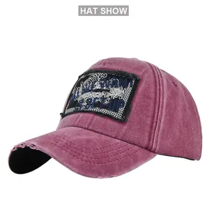 Macro detail of purple washed baseball cap showing distressed brim and vintage patch