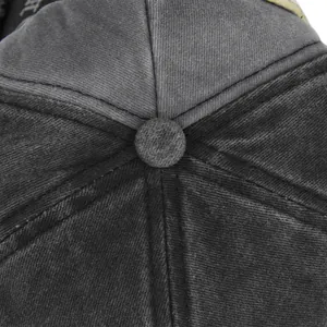 Close-up of the vintage washed cotton crown and stitched button on the baseball cap