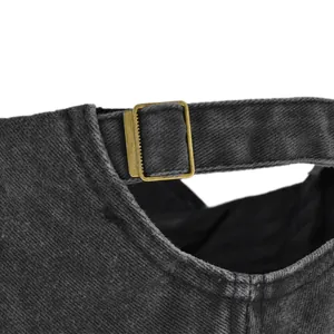 Close-up of adjustable bronze metal buckle and stitching on vintage baseball cap