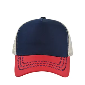 Detail of red curved brim featuring blue wavy stitching on a mesh trucker baseball cap