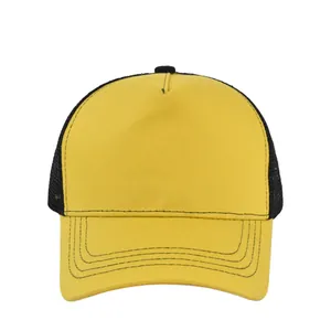 Detailed view of the yellow cotton front panel and black breathable mesh of the trucker hat