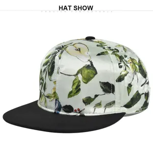 Detail of light green satin snapback hat featuring realistic pear and leaf floral prints