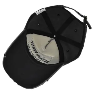 Close-up of vintage distressed baseball cap detailing 100% cotton fabric and metal buckle