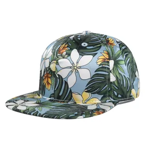 Detailed view of the tropical floral print on a snapback hat with palm leaves