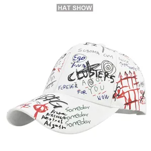Close-up of vibrant street art graffiti and bold 'Ego' embroidery on a white baseball cap
